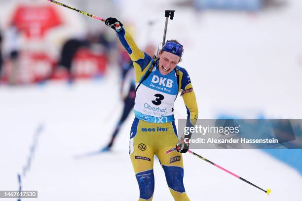 Hanna Oeberg of Sweden celebrates as she approaches the finish line to win the Women 12.5 km Mass Start at the IBU World Championships Biathlon...