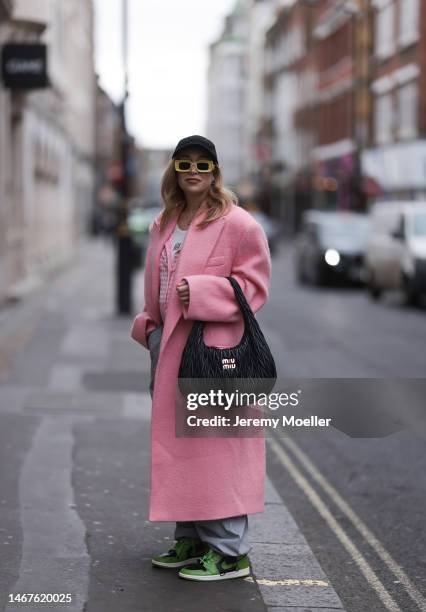 Sonia Lyson seen wearing Loewe yellow sunglasses, Miu Miu Wandler black leather shoulder bag, Marc Cain checked rose white cardigan, Bershka grey...