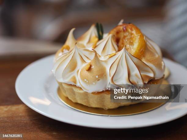 yuzu tart sweet food dessert on white plate - obsttorte stock-fotos und bilder