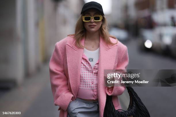 Sonia Lyson seen wearing Loewe yellow sunglasses, Miu Miu Wandler black leather bag, Marc Cain checked rose white cardigan, Bershka grey parachute...