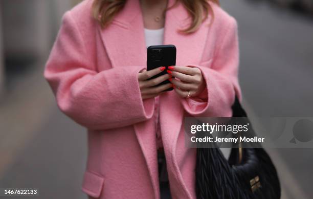 Sonia Lyson seen wearing Miu Miu Wandler black leather shoulder bag, Loewe white logo top, The Frankie Shop rose pink oversized long wool coat,...