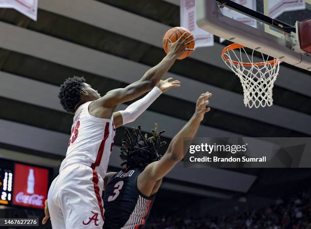 Nick Pringle of the Alabama Crimson Tide pulls down a first half rebound over Kario Oquendo of the Georgia Bulldogs at Coleman Coliseum on February...