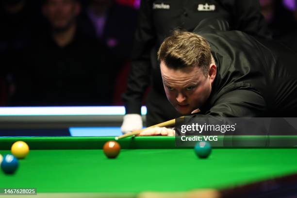 Shaun Murphy of England plays a shot in the final match against Robert Milkins of England on day seven of 2023 Betvictor Welsh Open at Venue Cymru on...