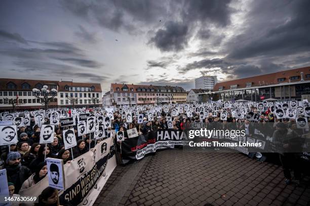 People hold of the 2020 mass shooting while the commemorates on February 19, 2023 in Hanau, Germany. On February 19, 2020 Tobias Rathjen shot dead...