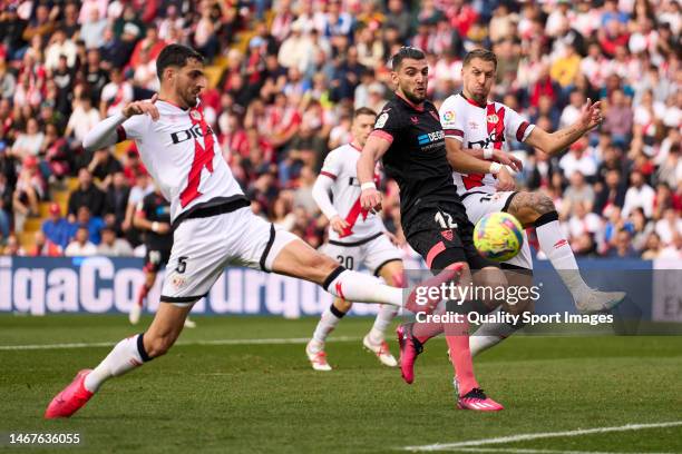 Alejandro Catena of Rayo Vallecano battle for the ball with Rafa Mir of Sevilla FC during the LaLiga Santander match between Rayo Vallecano and...