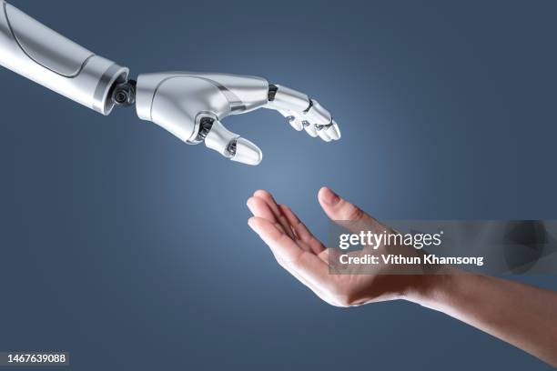 artificial intelligence robot hand and human hand - robot stock pictures, royalty-free photos & images