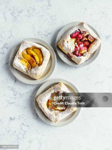 danish pastries on plates on white background - danish pastry stock pictures, royalty-free photos & images