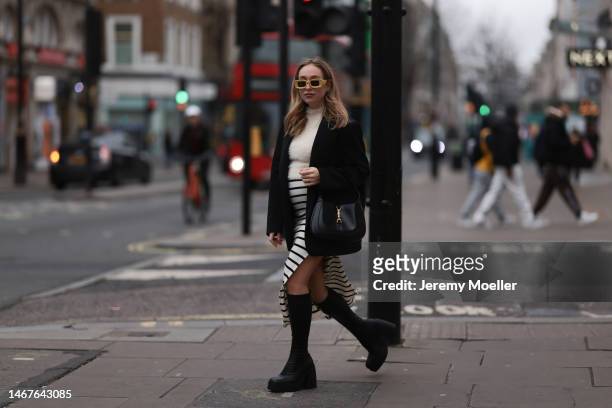 Sonia Lyson seen wearing Loewe yellow sunglasses, Zara creme white fluffy turtleneck top, Zara black oversized blazer, Bershka white striped long...