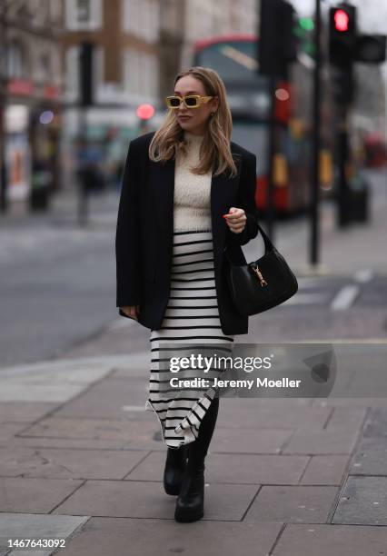 Sonia Lyson seen wearing Loewe yellow sunglasses, Zara creme white fluffy turtleneck top, Zara black oversized blazer, Bershka white striped long...