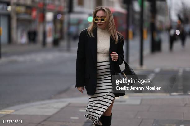 Sonia Lyson seen wearing Loewe yellow sunglasses, Zara cream white fluffy turtleneck top, Zara black oversized blazer, Bershka white striped long...