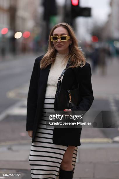 Sonia Lyson seen wearing Loewe yellow sunglasses, Zara cream white fluffy turtleneck top, Zara black oversized blazer, Bershka white striped long...