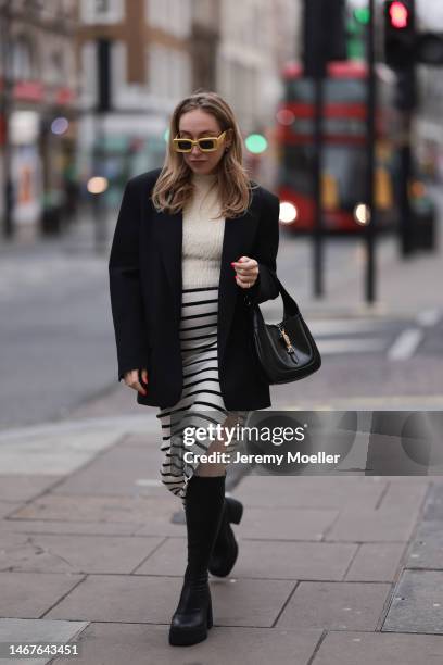 Sonia Lyson seen wearing Loewe yellow sunglasses, Zara cream white fluffy turtleneck top, Zara black oversized blazer, Bershka white striped long...