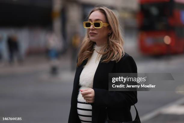 Sonia Lyson seen wearing Loewe yellow sunglasses, Zara cream white fluffy turtleneck top, Zara black oversized blazer, Bershka white striped long...