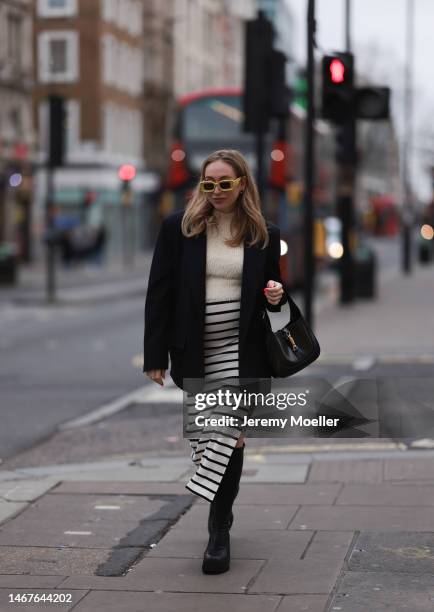 Sonia Lyson seen wearing Loewe yellow sunglasses, Zara cream white fluffy turtleneck top, Zara black oversized blazer, Bershka white striped long...