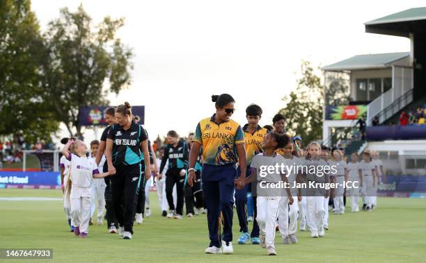 Players of New Zealand and Sri Lanka make their way out ahead of the National Anthems ahead of the ICC Women's T20 World Cup group A match between...