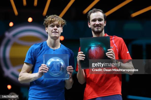 Jannik Sinner of Italy and Daniil Medvedev pose for a photo with the runners up and winners trophies respectively after the Men's Singles Final on...