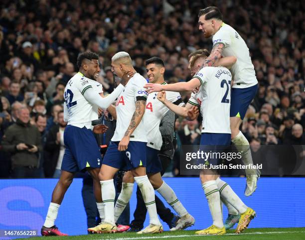 Emerson of Tottenham Hotspur celebrates after scoring the team's first goal, as they hold the throat of Richarlison, with teammates during the...