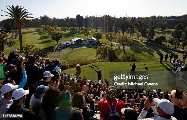 Tiger Woods of the United States follows his shot from the first tee during the final round of the Genesis Invitational at Riviera Country Club on...