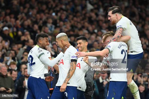 Emerson of Tottenham Hotspur celebrates after scoring the team's first goal, as they hold the throat of Richarlison, with teammates during the...