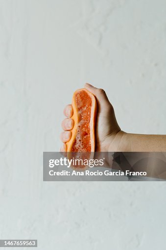 Hand squeezing a Grapefruit Hand squeezing a Grapefruit