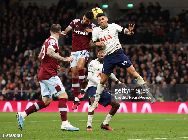Emerson Palmieri of West Ham United contends for the aerial ball with Cristian Romero of Tottenham Hotspur during the Premier League match between...