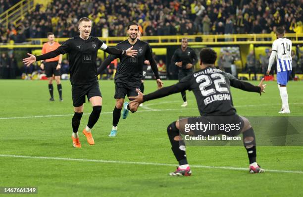 Marco Reus of Borussia Dortmund celebrates after scoring the team's third goal from a free kick with teammates during the Bundesliga match between...