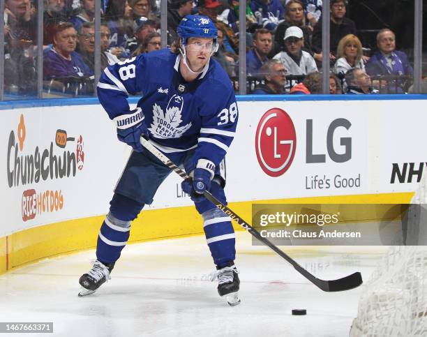 Rasmus Sandin of the Toronto Maple Leafs skates with the puck against the Montreal Canadiens during an NHL game at Scotiabank Arena on February 18,...