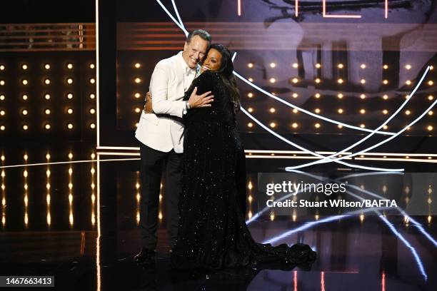 Richard E. Grant and Alison Hammond on stage during the EE BAFTA Film Awards 2023 at The Royal Festival Hall on February 19, 2023 in London, England.
