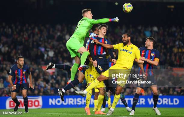 Marc-Andre ter Stegen of FC Barcelona punches the ball clear whilst under pressure from Anthony Lozano of Cadiz CF during the LaLiga Santander match...