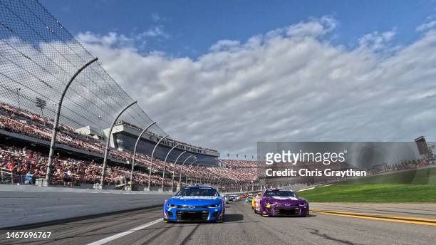 Kyle Larson, driver of the HendrickCars.com Chevrolet, and Alex Bowman, driver of the Ally Chevrolet, lead the field on a pace lap prior to the...