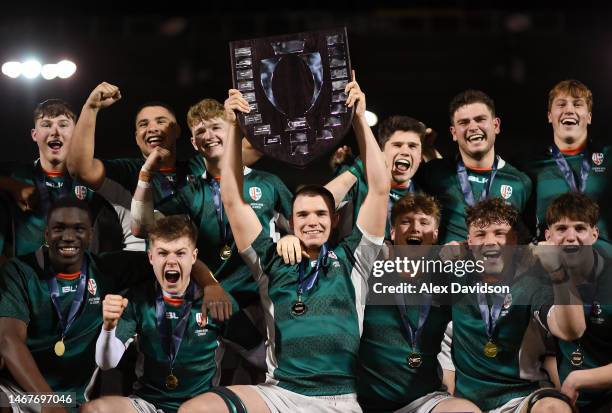 Finn Worley Brady of London Irish lifts the Premiership Rugby U18 Academy League Shield after the Premiership Rugby U18 League Final between...