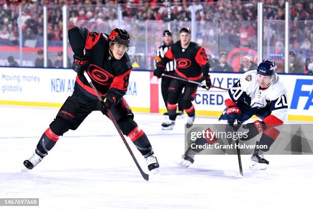 Teuvo Teravainen of the Carolina Hurricanes moves the puck against Lars Eller of the Washington Capitals during the 2023 Navy Federal Credit Union...