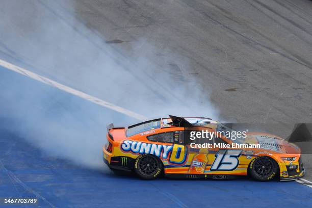 Riley Herbst, driver of the SunnyD Ford, spins after an on-track incident during the NASCAR Cup Series 65th Annual Daytona 500 at Daytona...