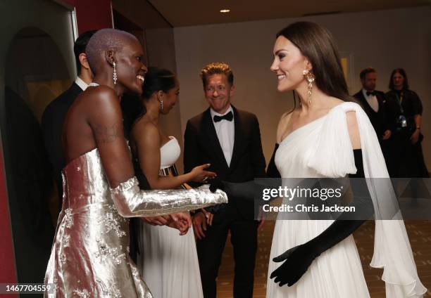 Catherine, Princess of Wales, speaks to EE Rising Star nominee Sheila Atim during the EE BAFTA Film Awards 2023 at The Royal Festival Hall on...