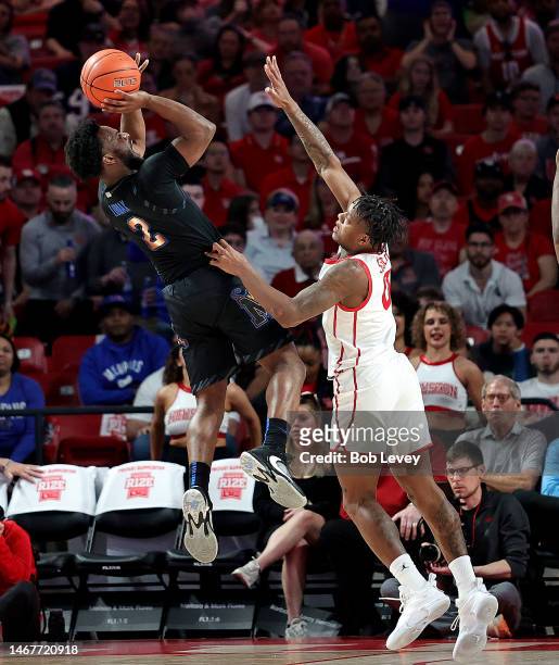 Alex Lomax of the Memphis Tigers shoots over Marcus Sasser of the Houston Cougars during the second half at Fertitta Center on February 19, 2023 in...
