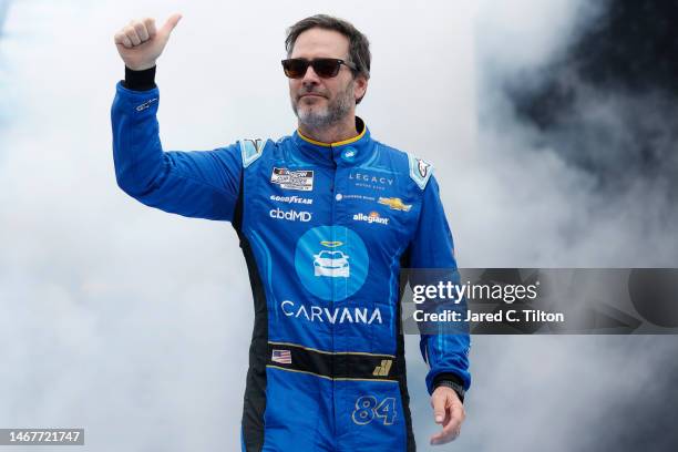 Jimmie Johnson, driver of the Carvana Chevrolet, gives a thumbs up to fans as he walks onstage during driver intros prior to the NASCAR Cup Series...