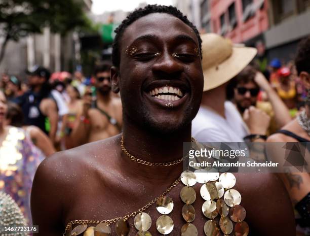 Reveller smiles during the annual street block party know as "Explode Coracao" on the third day of Carnival on February 19, 2023 in Sao Paulo,...
