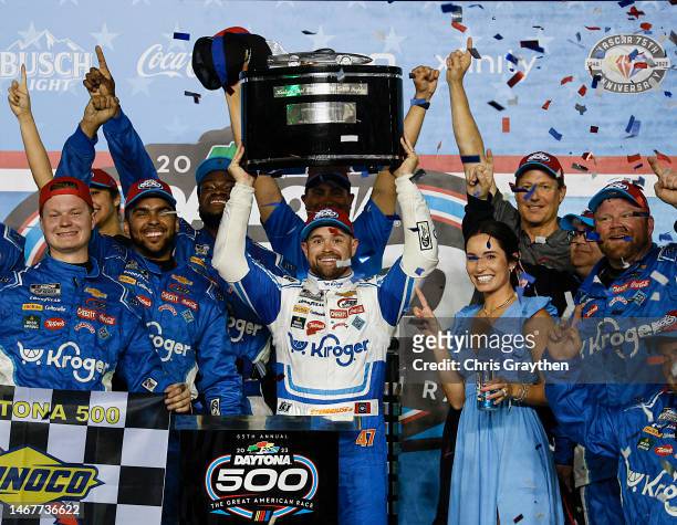 Ricky Stenhouse Jr., driver of the Kroger/Cottonelle Chevrolet, lifts the Harley J. Earl trophy in victory lane after winning the NASCAR Cup Series...