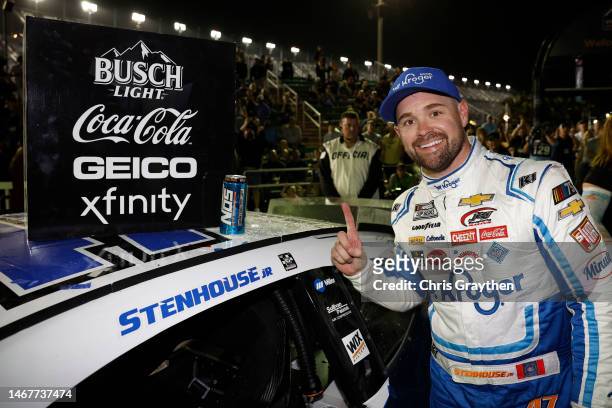 Ricky Stenhouse Jr., driver of the Kroger/Cottonelle Chevrolet, poses next to his winner sticker in victory lane after winning the NASCAR Cup Series...