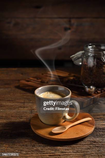 cup of coffee with smoke and coffee beans on old wooden background - coffee bildbanksfoton och bilder