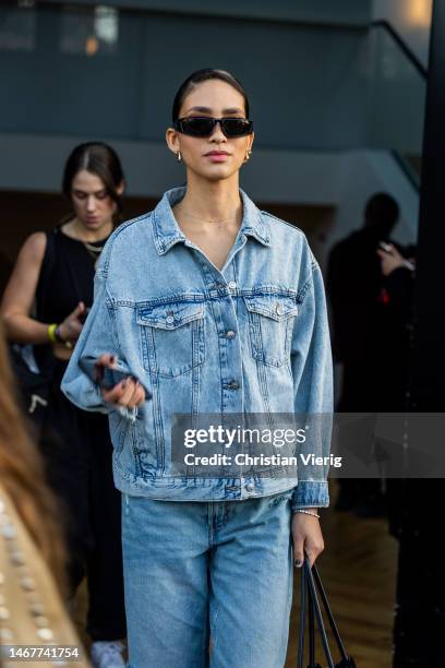 Model wears denim jacket, jeans outside Nensi Dojaka during London Fashion Week February 2023 on February 19, 2023 in London, England.