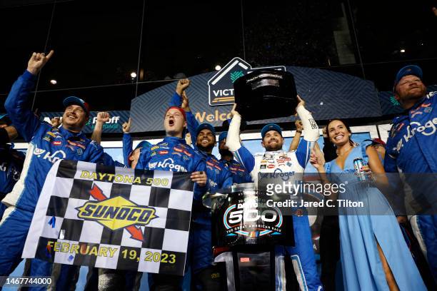 Ricky Stenhouse Jr., driver of the Kroger/Cottonelle Chevrolet, lifts the Harley J. Earl trophy in victory lane after winning the NASCAR Cup Series...