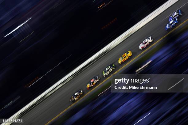 Kyle Busch, driver of the 3CHI Chevrolet, leads the field during the NASCAR Cup Series 65th Annual Daytona 500 at Daytona International Speedway on...
