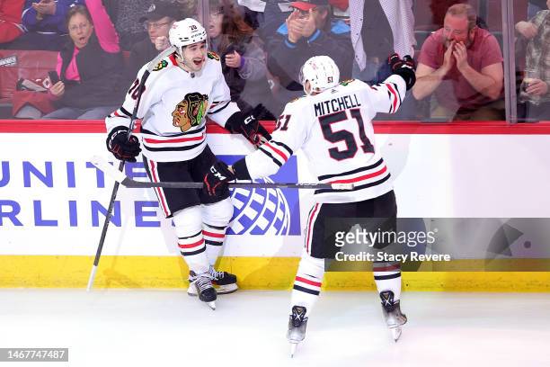 Cole Guttman of the Chicago Blackhawks is congratulated by Ian Mitchell following a goal against the Toronto Maple Leafs during the third period at...