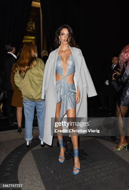 Sofia Resing wears silver cut out dress, laced heels outside Julien Macdonald during London Fashion Week February 2023 on February 19, 2023 in...