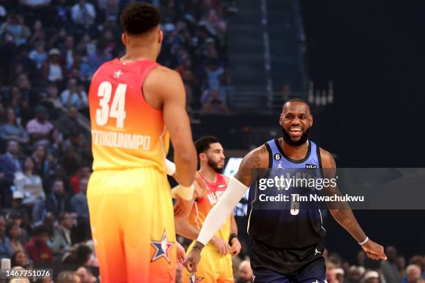 LeBron James of the Los Angeles Lakers celebrates as Giannis Antetokounmpo of the Milwaukee Bucks looks on during the 2023 NBA All Star Game between...