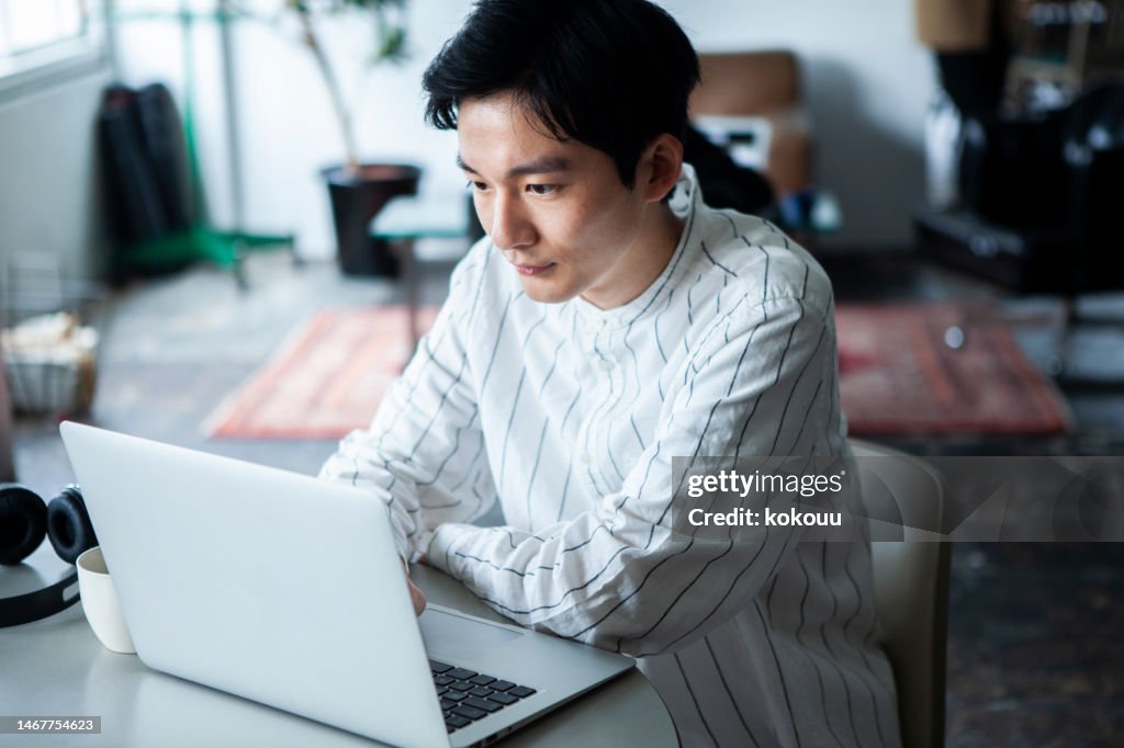 Pensive man working on laptop in the office