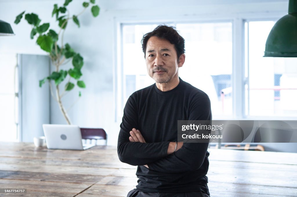 Portrait of a man looking at a camera in a modern, stylish office