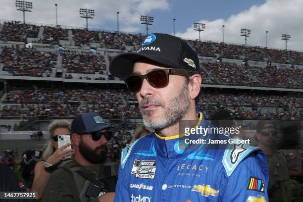 Jimmie Johnson, driver of the Carvana Chevrolet, walks the grid prior to the NASCAR Cup Series 65th Annual Daytona 500 at Daytona International...