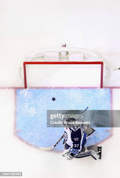 Connor Hellebuyck of the Winnipeg Jets pauses after giving up the game-winning goal to Miles Wood of the New Jersey Devils at the Prudential Center...